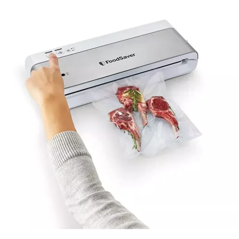 Máquina de vácuo FoodSaver VS0100X — botão rotativo, inclui rolo de filme e 4 sacos de vácuo, prateado-branco