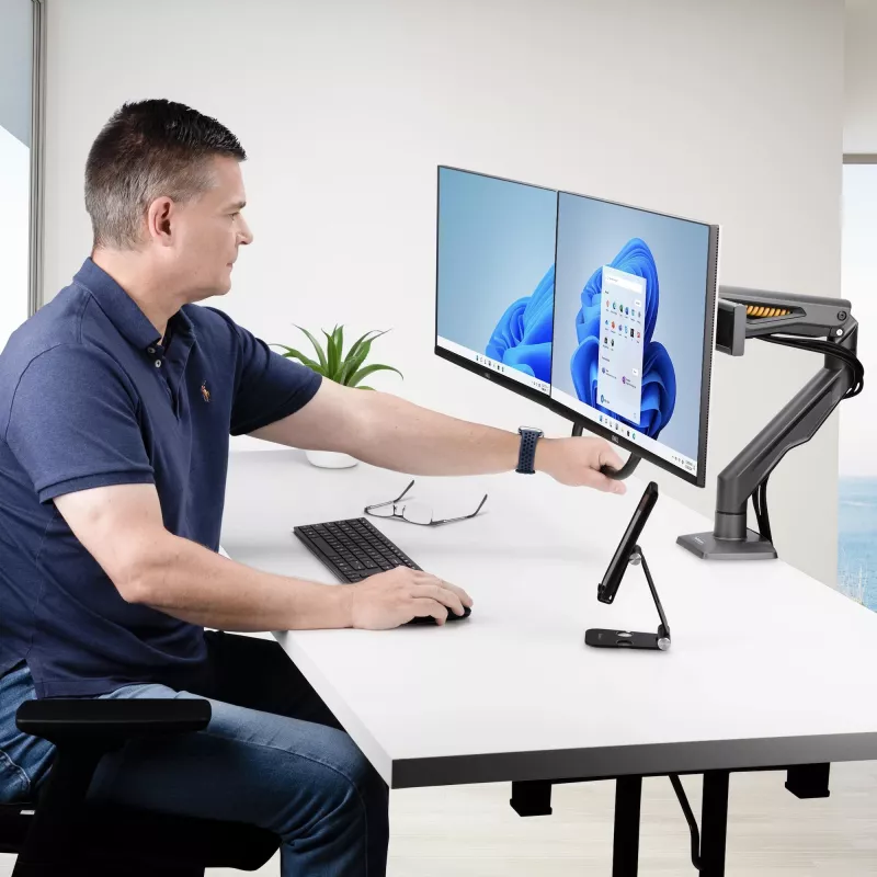 Suporte de secretária StarTech.com braço duplo para monitor com barra transversal, para ecrãs até 27 polegadas, VESA 75x75/100x100, máx. 33 lb/15 kg, aperto em C, totalmente articulado, mola mecânica, TAA